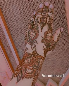 the hand is decorated with henna on it