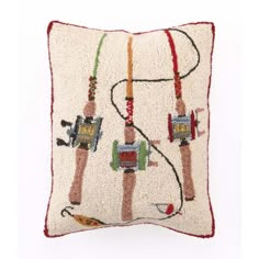 an embroidered pillow with two people on the front and one is holding a fishing rod