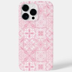 an iphone case with pink and white flowers on it, in front of a gray background