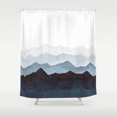 a blue and white shower curtain with mountains in the background