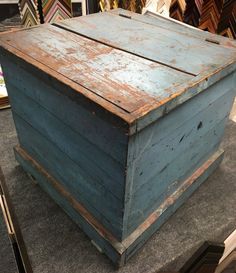 an old wooden box sitting on top of a table next to other pictures and frames