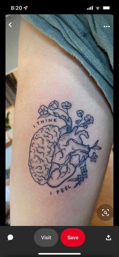 a tattoo on the leg of a woman with a heart and brain in it's center