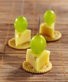 small crackers with cheese and green fruit on them