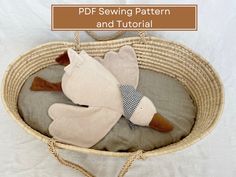 a stuffed animal in a basket with text overlay that reads, pdf sewing pattern and tutorial