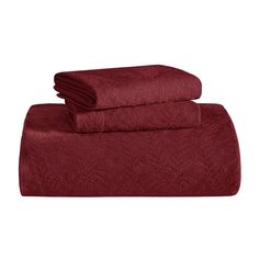 an image of two towels on top of each other in maroon color, one folded and the other rolled up