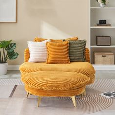 a living room with a couch, chair and bookshelf on the wall behind it