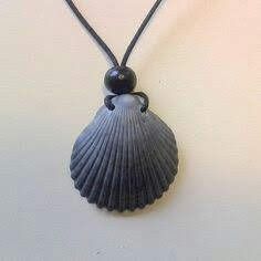 a necklace with a black bead hanging from it's back end on a leather cord