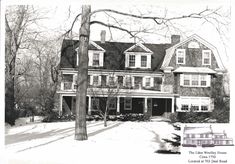 an old black and white photo of a large house in the winter with snow on the ground