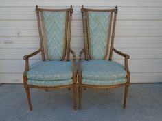 two chairs sitting next to each other in front of a garage door