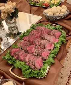 a table topped with lots of meat and lettuce