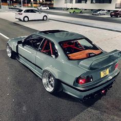 a grey car parked on the side of a road