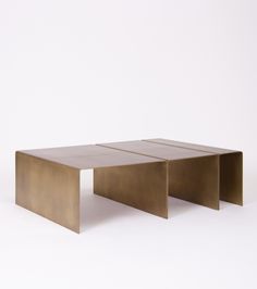 a coffee table made out of metal with two sections on each side and one section at the end