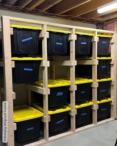 several bins are stacked on shelves in a storage room with yellow and black containers