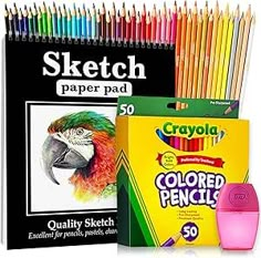 the crayon sketch pad is next to a box of colored pencils and an adult coloring book