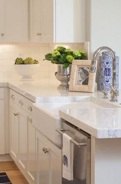 a white kitchen with blue and white accents