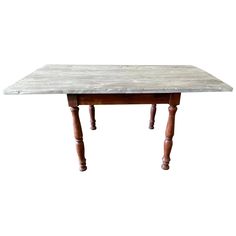 a wooden table sitting on top of a white floor