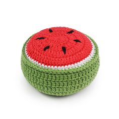 a crocheted watermelon cushion sitting on top of a white surface