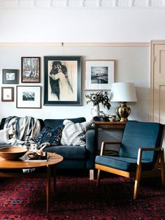 a living room filled with furniture and pictures on the wall