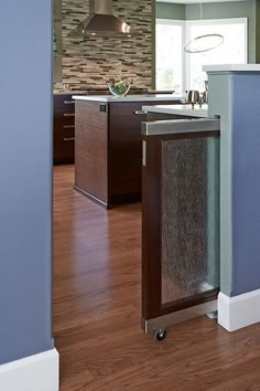 a kitchen with blue walls and wooden floors