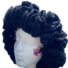 a white mannequin head with black curly hair