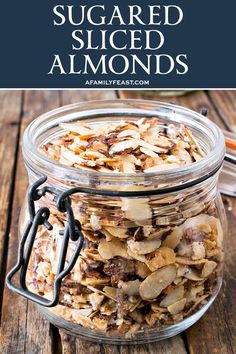 a glass jar filled with sliced almonds on top of a wooden table