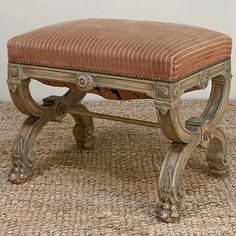 an old wooden bench sitting on top of a rug