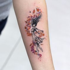 a woman's arm with an artistic tattoo design on the left side of her body