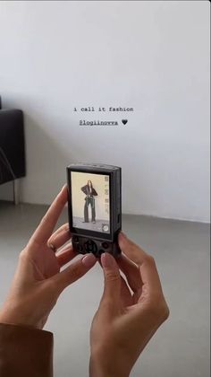 someone is holding up their cell phone to take a picture with the image on it