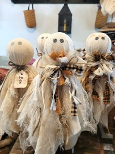 three burlap cloth stuffed animals sitting on top of a table