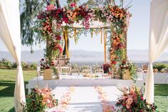 an outdoor wedding setup with flowers and greenery