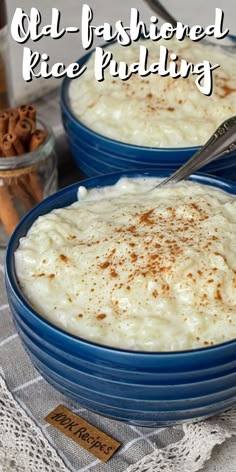 two blue bowls filled with rice pudding on top of a table