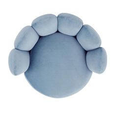 a blue round pillow with five pillows on the front and one is shaped like an animal's paw