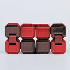 red and brown containers stacked on top of each other in front of a white background