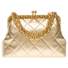 Extremely​ ​Rare​ ​Chanel​ ​shoulder​ ​bag​ ​in​ ​metallic​ ​gold​ ​quilted​ ​leather,​ ​gold​ ​metal​ ​trim,​ ​golden​ ​metal​ ​handle​ ​interlaced​ ​with​ ​gold​ ​leather​ ​for​ ​carrying​ ​hand​ ​or​ ​shoulder​ ​or​ ​crossbody​ ​carry Mechanical​ ​opening​ ​by​ ​golden​ ​metal​ ​balls Metallic​ ​gold​ ​leather​ ​interior​ ​lining,​ ​one​ ​zippered​ ​pocket Signature:​ ​"Chanel®Made​ ​in​ ​Italy" Date:​ ​1994/1996 Dimensions:​ ​18x12x5​ ​cm​ ​(7,1x4,7x2​ ​Inches) Chain​ ​length:​ ​57​ ​cm​ ​(2 Vintage Chanel Bag, Chanel Brand, Chanel Shoulder Bag, Togo Leather, Metal Trim, Handbag Straps, Vintage Chanel, Quilted Leather, Gold Leather