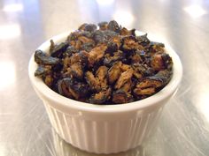 a white bowl filled with raisins on top of a table