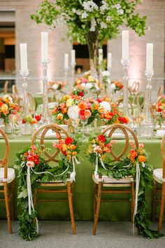 a table set up with chairs and flowers