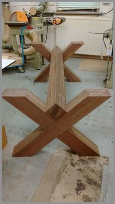 a wooden sculpture sitting on top of a table in a room filled with woodworking tools