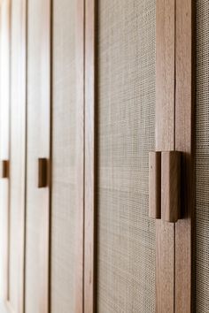 a row of wooden cupboards sitting next to each other on top of a wall