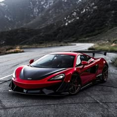 a red and black sports car on the road