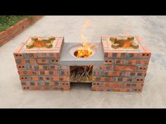 a fire pit made out of cinder blocks with flames coming out of the top and sides