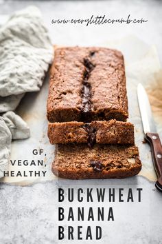 sliced loaf of chocolate banana bread on top of parchment paper next to knife and napkin