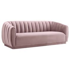 a pink velvet sofa with pleated upholstered back and arms, viewed from the front