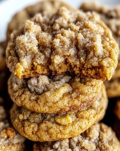 a pile of cookies sitting on top of each other in front of a white plate