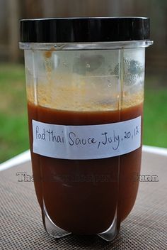 a jar filled with sauce sitting on top of a table