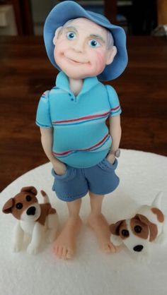 a cake with a boy and three dogs on it