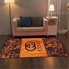 a living room area with a couch, lamp and rugs on the hardwood floor