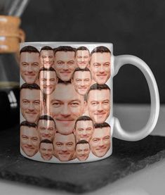 a coffee mug with a photo of the faces of two men on it, sitting on a counter