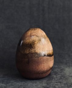 an egg sitting on top of a gray surface