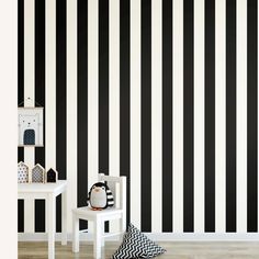 a black and white striped wallpaper in a child's room with two small tables