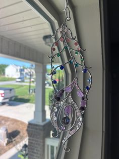 a wind chime hanging from the side of a window